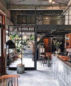 the inside of a school bus restaurant with tables, chairs and food items on display