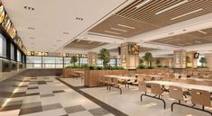 an empty cafeteria with tables and chairs in the center, plants on the wall above them