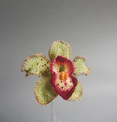 a crocheted flower in a glass vase