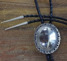 Beautiful vintage sterling silver concho-form bolo tie. The slide measures 2 5/8" tall and 2 1/4" wide. The leather chord measures 46" long, including the sterling tips. The bolo slide is stamped "Sterling". Concho Belt