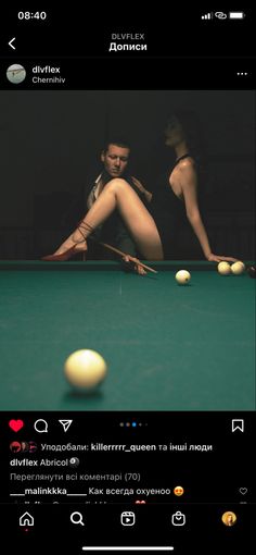 a man and woman are playing pool in front of the camera on their cell phone