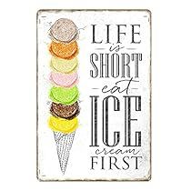 a sign that says life is short eat ice cream first and has an image of a cone