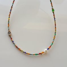 Introducing our Colorful Rainbow Small Glass Crystal Minimal Beaded Necklace, the perfect accessory to add a pop of color to any outfit! This dainty necklace features a stunning gold seed bead chain that complements the vibrant rainbow glass crystals beautifully. A versatile piece that can be dressed up or down, making it ideal for everyday wear or special occasions. This necklace also makes a thoughtful gift for bridesmaids or your bestie. Add a touch of elegance and charm to your jewelry colle Beaded Necklaces With Spacer Beads As Gift, Party Beaded Necklaces With Letter And Round Beads, Party Letter Beaded Necklaces, Rainbow Glass, Bestie Gifts, Jewelry Lookbook, Dainty Necklace, Beaded Chain, Bridesmaid Gifts