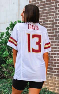 Who's ready for FOOTBALL?! Our latest NIL Retro Brand jersey is sure to be a fan favorite! Represent #13 Jordan Travis - our Seminole star Quarterback! Details: *OFFICIALLY LICENSED* Retro Brand College Classic Jersey 100% Polyester V-Neckline, Full Length, Short Sleeve Features “#13” and “Travis” Graphic Oversized, Unisex, True Jersey Fit Sydney is wearing size Small Garment measurements in inches: Small = Bust: 20” / Length: 31” Medium = Bust: 22” / Length: 32” Large = Bust: 24” / Length: 33” White Jordans, Fashion Bottoms, Retro Brand, Florida State Seminoles, Sarasota Florida, Auburn Tigers, Georgia Bulldogs, Alabama Crimson, Alabama Crimson Tide