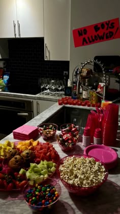 a kitchen counter topped with lots of candy and candies next to a microwave oven