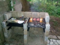 an outdoor grill with food cooking on it