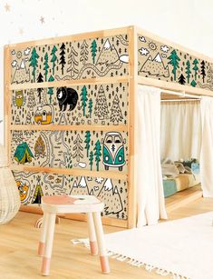 a child's room with a bunk bed and play area in the corner, decorated with animals and trees