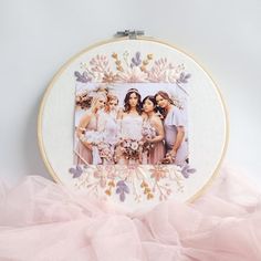 the bridesmaids are posing together in front of an embroidery pattern on a hoop