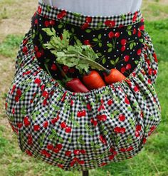 a woman wearing a black and white checkered skirt with red cherries on it