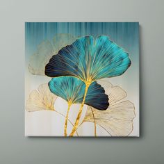 two blue leaves on a white background with gold foil in the shape of a flower