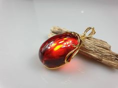 Deep Red amber pendant. Perfect stunning ruby red teardrop shape. Gold plated pendant (with stamping-hallmark). High quality. Teardrop shape elegant pendant. All natural parts, not plastic. Weight: 14.00 gr Pendant size: 5.5 x 2.6 cm MATCHING Earrings: https://www.etsy.com/uk/listing/912802337/ruby-red-amber-earrings-gold-plated?ref=shop_home_active_4&frs=1 This item was made of natural Baltic Amber. All the amber used in my jewelry is collected in my home country Lithuania. I sell only genu Formal Jewelry With Cabochon Teardrop Pendant, Formal Cabochon Teardrop Pendant Jewelry, Formal Teardrop Cabochon Pendant Jewelry, Formal Teardrop Pendant Jewelry With Cabochon, Amber Teardrop Cabochon Necklace, Cabochon Drop Jewelry For Gifts, Amber Teardrop Cabochon Jewelry, Red Drop Beads For Jewelry Making, Red Drop Gemstone Jewelry