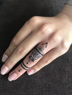 a woman's hand with a tattoo on it