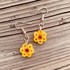 the earrings are made out of yellow and orange plastic beads on silver earwires