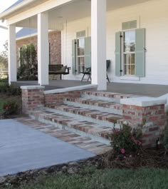 a porch with steps leading up to the front door