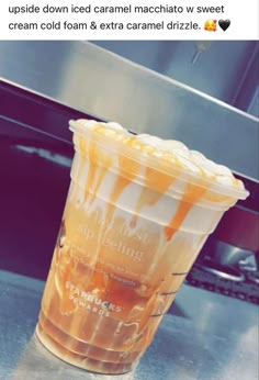 a plastic cup filled with orange liquid sitting on top of a counter