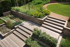 an aerial view of a garden with wooden steps