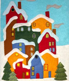 a quilted christmas scene with houses and trees