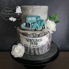 a cake decorated with an old truck and flowers