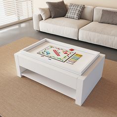 a coffee table with a game on it in front of a white couch and window