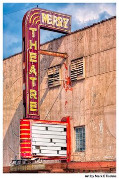 the marquee sign for merry theatre is painted red and yellow with white letters