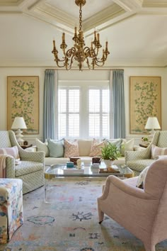 a living room filled with lots of furniture and a chandelier hanging from the ceiling