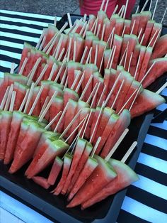 watermelon skewers are arranged on a tray