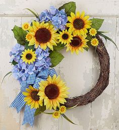 a wreath with sunflowers and blue hydrangeas