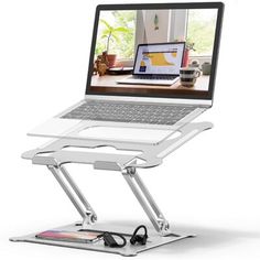 a laptop is sitting on a stand with wheels