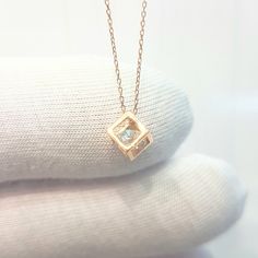 - Cube pendant necklace is made with high-quality 14K real solid gold. - The Inside of the cube, there is a diamond cut cubic zirconia stone and it is moving. - The dimensions of the cube is 0.5 X 0.5 X 0.5 cm. - This dainty, charm, tiny, delicate, cute and trendy pendant necklace has been artfully designed for timeless yet modern millennial fashion. - This 14K solid gold pendant comes with a beautiful matching free 14K real solid gold chain. - You receive the pendant in a beautiful and free gif Gold Square Pendant Necklace As Gift For Her, Gold Diamond-shaped Diamond Necklace, Gift Tarnish Resistant Cubic Zirconia Necklace, Rose Gold Diamond Necklace For Anniversary Gift, Square Pendant Necklace With Single Diamond For Anniversary, Minimalist Solitaire Necklace As Gift, Anniversary Necklace With Single Diamond Square Pendant, Anniversary Square Pendant Necklace With Single Diamond, Cubic Zirconia Square Pendant Necklace For Gifting