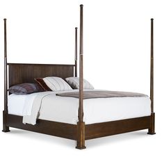 a bed with four posts and pillows on top of it, in front of a white background