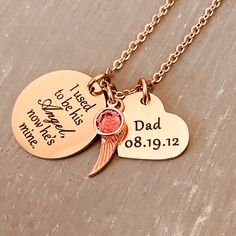 "Whether for yourself or for someone you care about, this endearing necklace will honor the dad, father, grandfather, or brother who is so very missed. D E S I G N D E T A I L S: - ENGRAVED DESIGN: 1- 7/8\" Stainless Steel plated Rose Gold Disc engraved with the sweet sentiment, \"I used to be his Angel, now he's mine.\" 1- Angel Wing Charm 1- 3/4\" engraved heart with name and date. 1- Durable Stainless Steel Chain in rose gold. - MATERIAL & MEASUREMENTS: Your engraved charms are made from Engraved Necklaces For Memorial, Personalized Jewelry For Father's Day Keepsake, Birthstone Necklace For Father's Day Anniversary Gift, Engraved Jewelry For Father's Day Commemoration, Hand Stamped Necklace For Anniversary And Father's Day, Mother's Day Memorial Necklace With Hallmark, Hand Stamped Necklace For Anniversary On Father's Day, Engraved Jewelry For Father's Day Memorial, Father's Day Memorial Engraved Jewelry