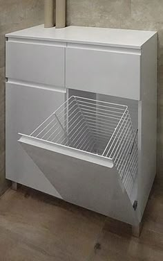 a white cabinet sitting next to a wall with a mirror on it's side