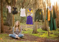 a woman sitting on the ground next to some clothes