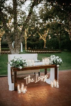 a wooden bench with candles on it and the word the less written in white letters