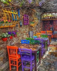 an outdoor dining area with colorful chairs and tables