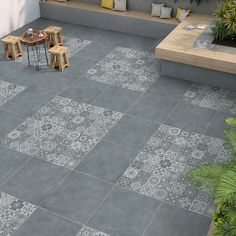 an outdoor patio with grey tiles on the floor