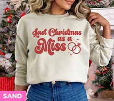 a woman wearing a sweatshirt that says just christmas as a miss