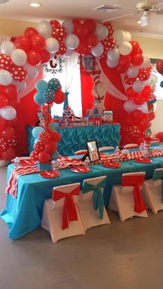 the table is decorated with red, white and blue balloons