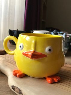 a yellow coffee cup with eyes on it