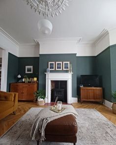 a living room filled with furniture and a flat screen tv mounted on a wall above a fire place