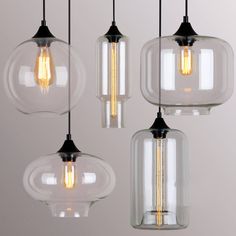 three clear glass pendant lights hanging from the ceiling with measurements for each bulb and height