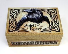 a wooden box with an image of a raven on it's front and the words spirit of the raven written in black