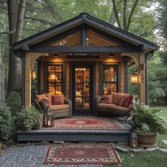 a small house with two couches and a rug on the ground in front of it