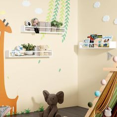 a child's bedroom with an elephant and giraffe wall decal