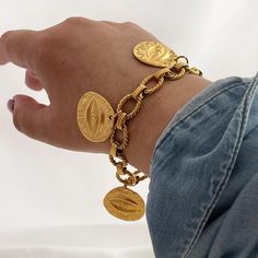 Evil Eye Charm Bracelet Featuring three big evil eye coin charms this gold chain bracelet will pull together every look. Not only will this charm bracelet look good on its own, but will make your outlook unforgettable. ---------------------------------------- M A T E R I A L S * 18K gold-plated stainless steel chain. * Link thickness: 2.5mm * Gold-plated over brass evil eye coin 28mm. * Water Resistant, Tarnish Free, Hypoallergenic * Different Chain lengths (from 6.5" to 9" inches long including the clasp). Choose the length from the dropdown menu. * Stainless steel closure.   ♥ YOUROCK JEWELS TIP ♥: Wear it alone or mix other chains with different lengths. ---------------------------------------- ★ B R A C E L E T  ★ Be sure to check out our bracelet collection below: https://yourockjewel Charm Bracelet Gold, Gold Chain Bracelet, Coin Bracelet, Greek Jewelry, Gold Charm Bracelet, Chunky Jewelry, Protection Bracelet, Bracelet Boho, Gold Bracelet Chain