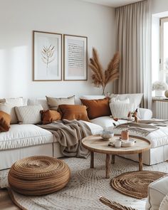 a living room filled with white furniture and lots of pillows on top of the couch