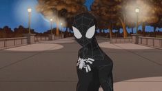 a spider - man is walking down the street in front of some trees and lights