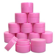 many pink plastic containers are stacked on top of each other