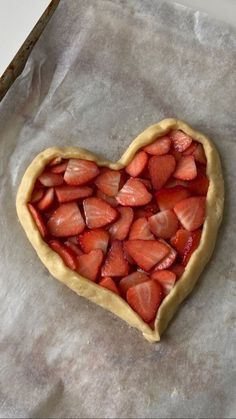 a heart shaped pastry sitting on top of a piece of wax paper