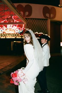 a bride and groom standing in front of a casino